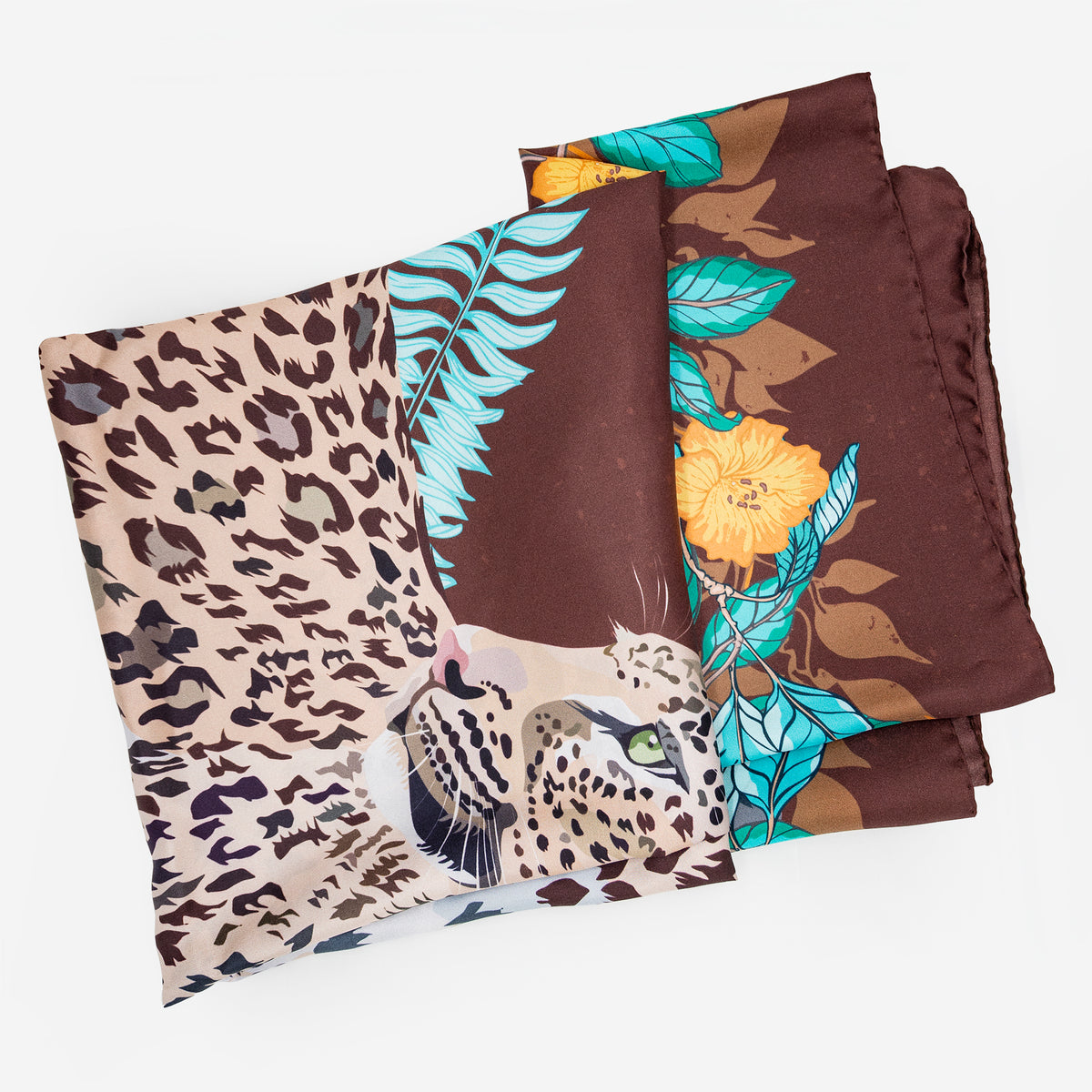Brown Leopard in Jungle Motif silk scarf folded, showing the leopard head, teal ferns and yellow blossoms